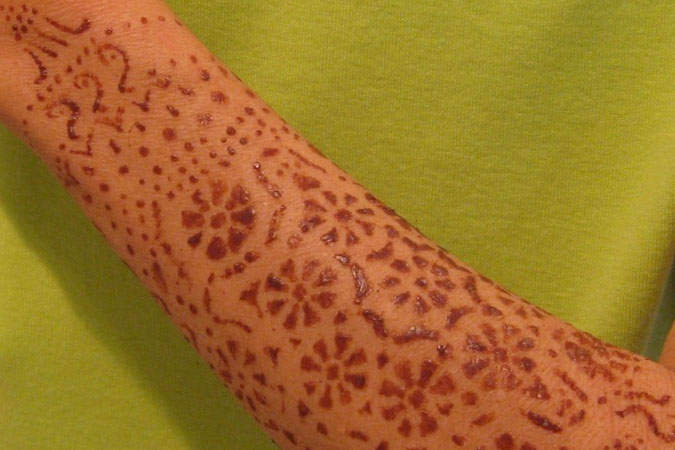 Cocoa powder makes a temporary tattoo, similar to Indian mehndi skin designs.