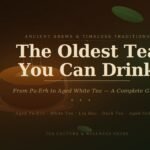 A steaming ceramic tea bowl surrounded by scattered tea leaves on a dark, rich background with the text "The Oldest Tea You Can Drink — From Pu-Erh to Aged White Tea, A Complete Guide."